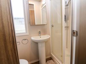 a bathroom with a sink and a shower at Caravan number 77 in Eyemouth +18 photos