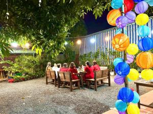 a group of people sitting at a table in a restaurant at Homestay & Camping Phan Thiet Beach in Ấp Bình Hưng