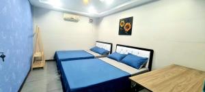 a small room with two beds and a table at Homestay & Camping Phan Thiet Beach in Ấp Bình Hưng