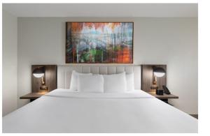 a bedroom with a large white bed and two lamps at La Quinta by Wyndham Knoxville Central Papermill in Knoxville +29 photos