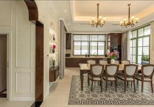 a dining room and kitchen with a table and chairs at Green Villas Tropical Phú Quốc in Phu Quoc