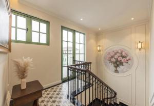 a hallway with stairs and a vase of flowers on the wall at Green Villas Tropical Phú Quốc in Phu Quoc