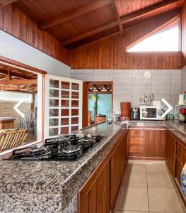 a kitchen with a stove and a counter top at Riba Brisa in Imbituba