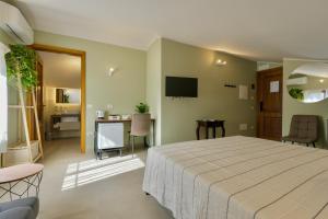 a bedroom with a large bed and a living room at Domus Fabia - Rooms & Apartments in San Gemini