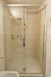 a shower with a glass door in a bathroom at Domus Fabia - Rooms & Apartments in San Gemini