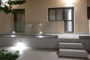a living room with a table and two chairs at Michail Old Harbour Residence in Kos +83 photos