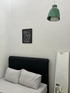 una camera da letto con testiera nera e specchio di Damar Tree Resort a Krui