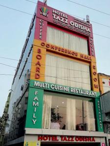 a building with many signs on the side of it at Hotel Tazzodisha Next in Bhubaneshwar
