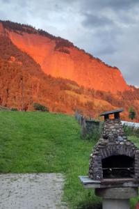 a stone oven in a field with a mountain at Apartment Oberwilen by Interhome in Vitznau