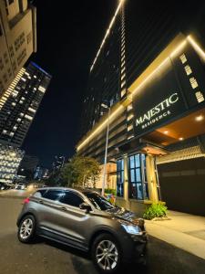 a silver suv parked in front of a building at Majestic Residence Klcc by Luxury in Kuala Lumpur