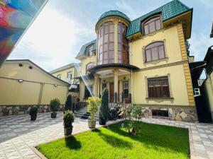 a large house with a tower on top of it at Soro Hotel in Dushanbe
