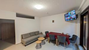 a living room with a couch and a table and chairs at Marco City Apartment Werne - Terrasse, Küche & WLAN in Werne an der Lippe
