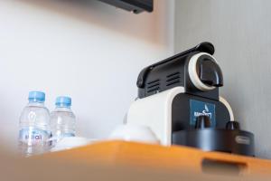 a coffee maker and bottles of water on a table at Mandarin Hotel & Spa Tanger in Tangier