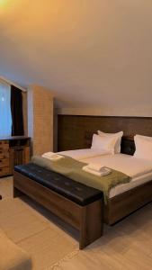 a bedroom with a large bed with a wooden headboard at Deluxe 707 in Borovets