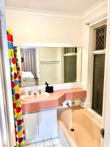 a bathroom with a sink and a bath tub at Affordable accommodation near Perth CBD in Perth +7 photos
