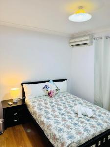 a bedroom with a bed with a blue and white comforter at Affordable accommodation near Perth CBD in Perth