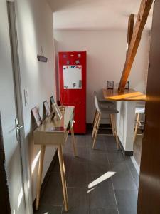 a kitchen with a red refrigerator and a table at Appartement Carnac, Centre bourg - 2 pieces in Carnac