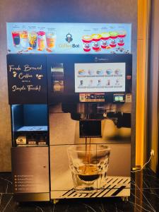 a coffee machine with a drink inside of it at Majestic Residence Klcc by Luxury in Kuala Lumpur +61 photos
