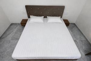 a large white bed in a small room at Takery Resort in Chittaurgarh +21 photos