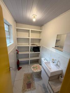 a bathroom with a toilet and a sink at Casa no Norte da Ilha in Florianópolis