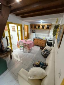 a kitchen and a living room with a couch and a table at Casa no Norte da Ilha in Florianópolis