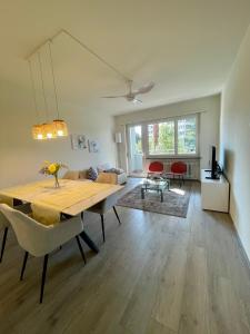 a living room with a dining table and a couch at RELAX Glicine Apartment in Locarno +11 photos