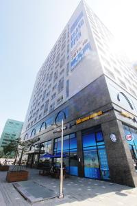 a large building with a sign on the side of it at Intercity Seoul Hotel in Seoul