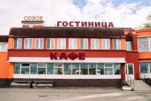 a kafe building with a sign on top of it at Hotel Orion in Nizhny Novgorod