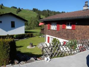 a house with a fence in front of it at Apartment Bella Vista by Interhome in Sörenberg