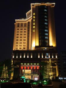 a large building with christmas trees in front of it at Grand Royal Hotel in Guangzhou