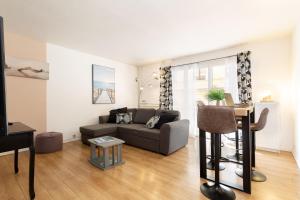 a living room with a couch and a table at Sweet Evasion - Wifi - Host Provence in Toulon