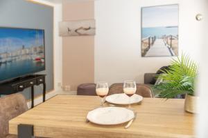 a dining room table with two glasses of wine at Sweet Evasion - Wifi - Host Provence in Toulon +32 photos