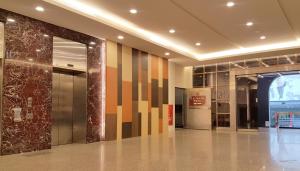 a lobby with a hallway with colorful walls and columns at SunWang Hotel in Puli