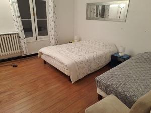 a hotel room with two beds and a window at Grand appart 2 chambres - max 6 pers in Vrigne-aux-Bois