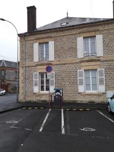 an empty parking lot in front of a brick building at Grand appart 2 chambres - max 6 pers in Vrigne-aux-Bois +4 photos