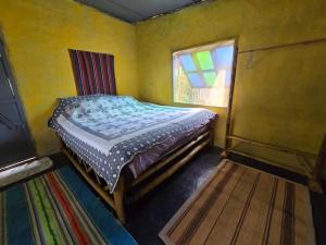 a bedroom with a bed in a room with a window at Faiza Farm home in Ban Nong Phai +36 photos