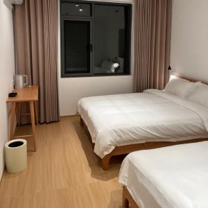 Postel nebo postele na pokoji v ubytování huazhi