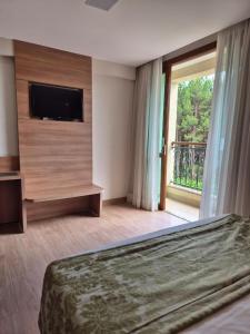 En eller flere senge i et værelse på Vista Azul Apart Hotel - Vista Pinheiros + 24 billeder