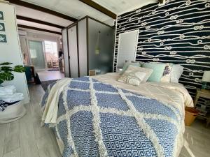 a bedroom with a blue and white bed and a wall at Casa Azul Experience at The Perry in Key West +42 photos