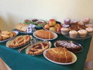 a table topped with different types of pies and pastries at Agriturismo Marinello in Pienza