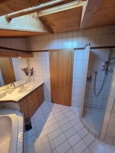 a bathroom with a shower and a sink at Glory Igls Lodge in Innsbruck +11 photos