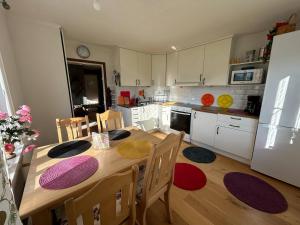a kitchen with a wooden table with chairs and a dining room at An excursion in Paradise in Söderköping