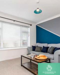 a living room with a couch and a table at DiscountsContractorsWIFIFree ParkingSmart TV in Durham