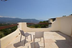 een balkon met 2 stoelen en uitzicht op de bergen bij Villa la Chiosella in Valle-di-Mezzana +36 foto's