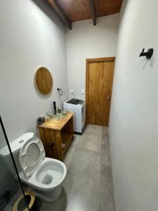 a bathroom with a toilet and a sink at Refugio del Mar 2 in Ocean Park
