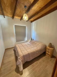 a bedroom with a bed and a wooden ceiling at Refugio del Mar 2 in Ocean Park