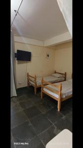 En eller flere senge i et værelse på Pousada Cantinho e Sossego casa 5