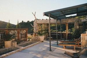 a patio with a pavilion with a bench at Mahakala Center in Petrovac na Moru