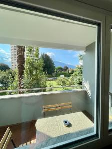 a window in a room with a bench and a view at RELAX Glicine Apartment in Locarno