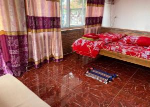 a bedroom with a bed with red sheets and curtains at Kampot Riverside GuessHouse in Phumĭ Ândong Pring